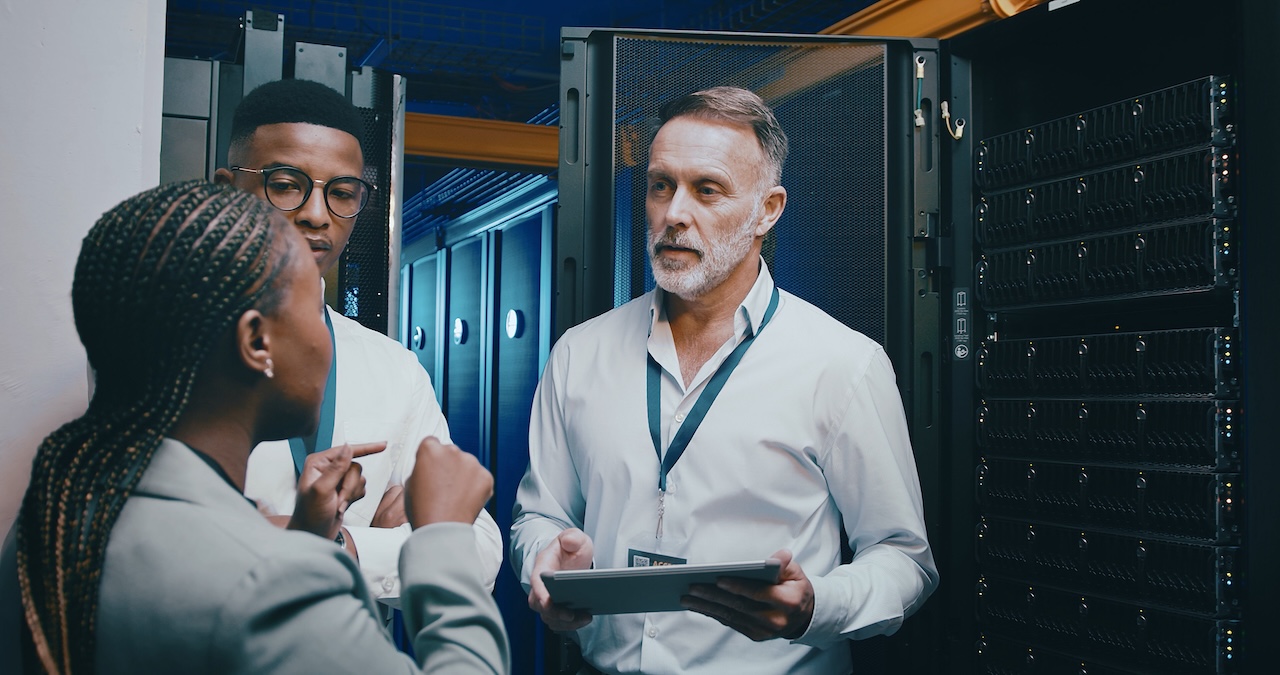 Server room, training and people on tablet for cybersecurity, diagnostics test or maintenance. IT team, meeting and workers with boss on digital tech for network, online database or technical support.